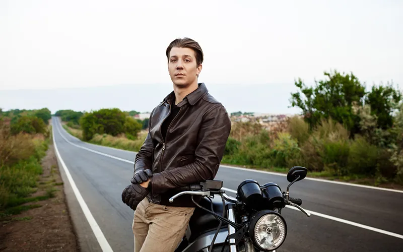 motor cycle jacket brown and bike on the road