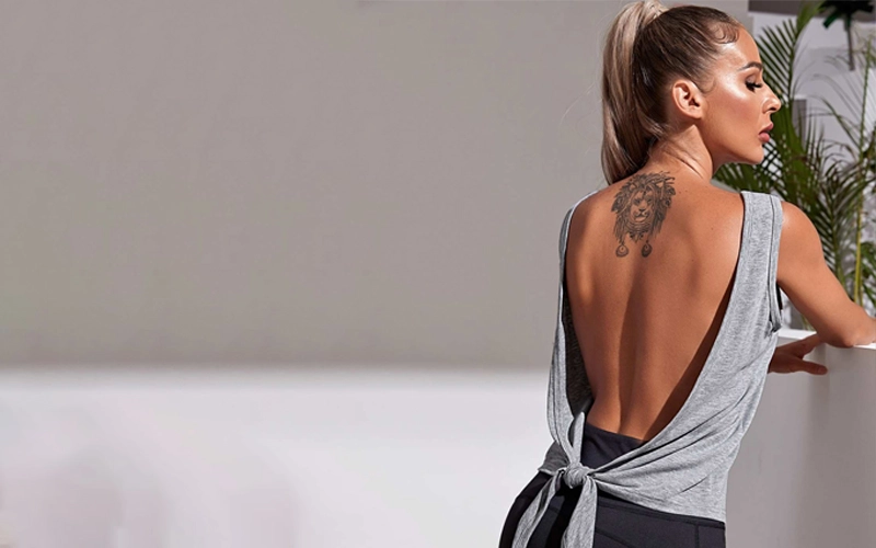 Woman wearing grey backless tank top