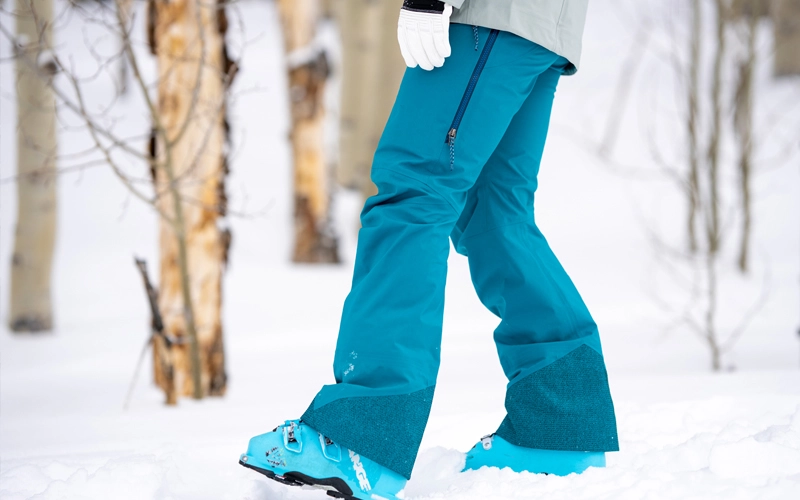 women in snow wearing blue Ski Pant