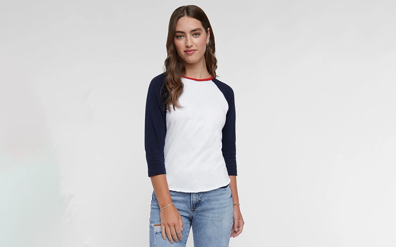 a women wearing a short sleeve Baseball T-shirt of white color having dark blue color sleeves