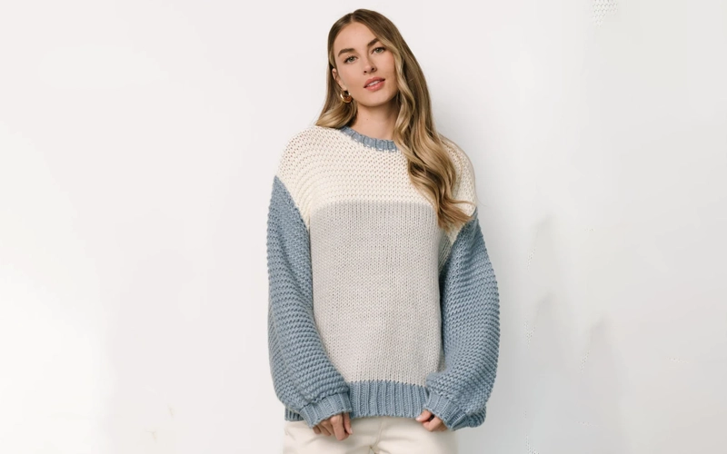a women wearing three different color layered Chunky Sweater.