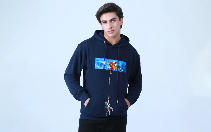 a boy wearing dark blue embriodered hoodie