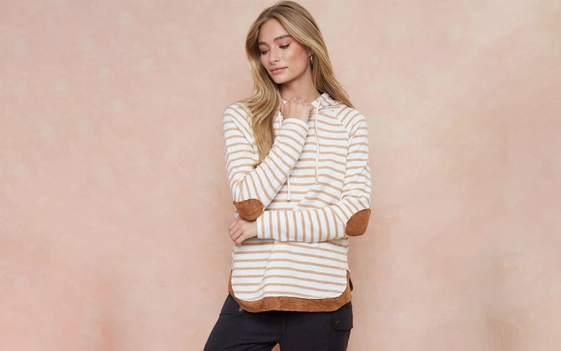 A women wearigg hoodie with elbow patches