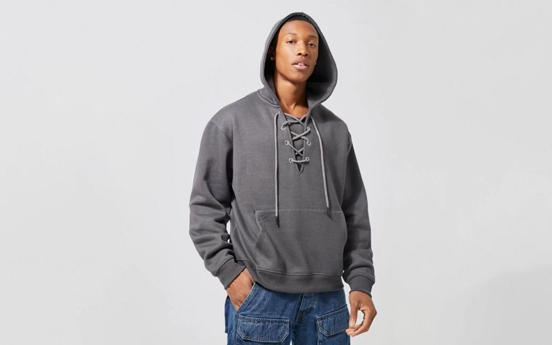 man wearing dark gray hoodie with lace up detail