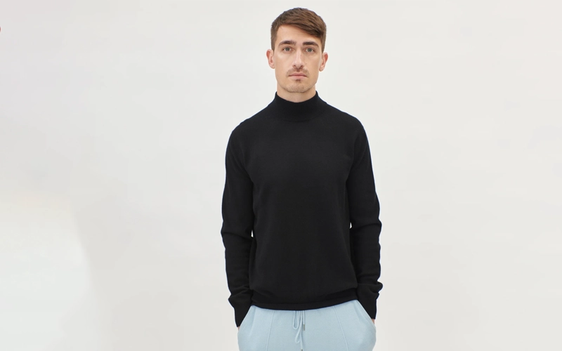 A man wearing dark black color Mock-neck Sweater