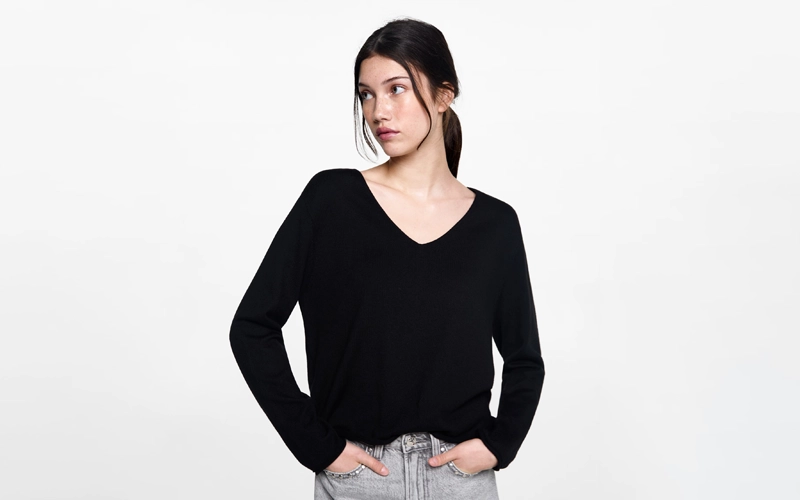 A women wearing dark black color V-neck Sweater