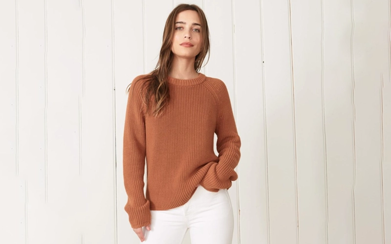 a women wearing light brown color Aran or Fisherman's Sweater a type of sweater in different types of sweaters
