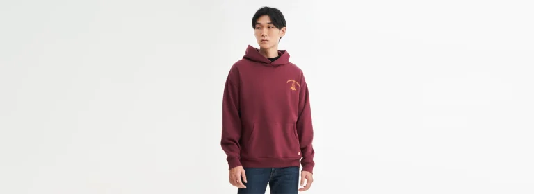 a man wearing a burgundy color hoodie