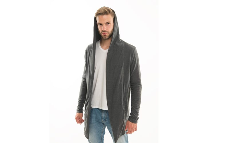 A man wearing a grey longline hoodie with a deep hood, paired with a white t-shirt and blue jeans, standing against a white background.