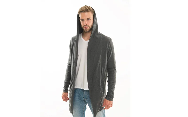 A man wearing a grey longline hoodie with a deep hood, paired with a white t-shirt and blue jeans, standing against a white background.