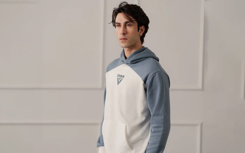 Men's two-tone pullover hoodie in white and blue with a graphic logo on the chest