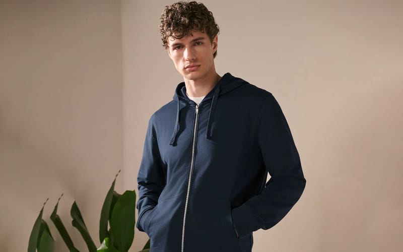 Men's navy blue zip-up hoodie with front pockets and a relaxed fit.