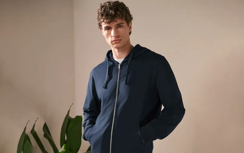 Men's navy blue zip-up hoodie with front pockets and a relaxed fit.