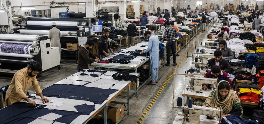 Sportswear production floor with workers manufacturing custom apparel